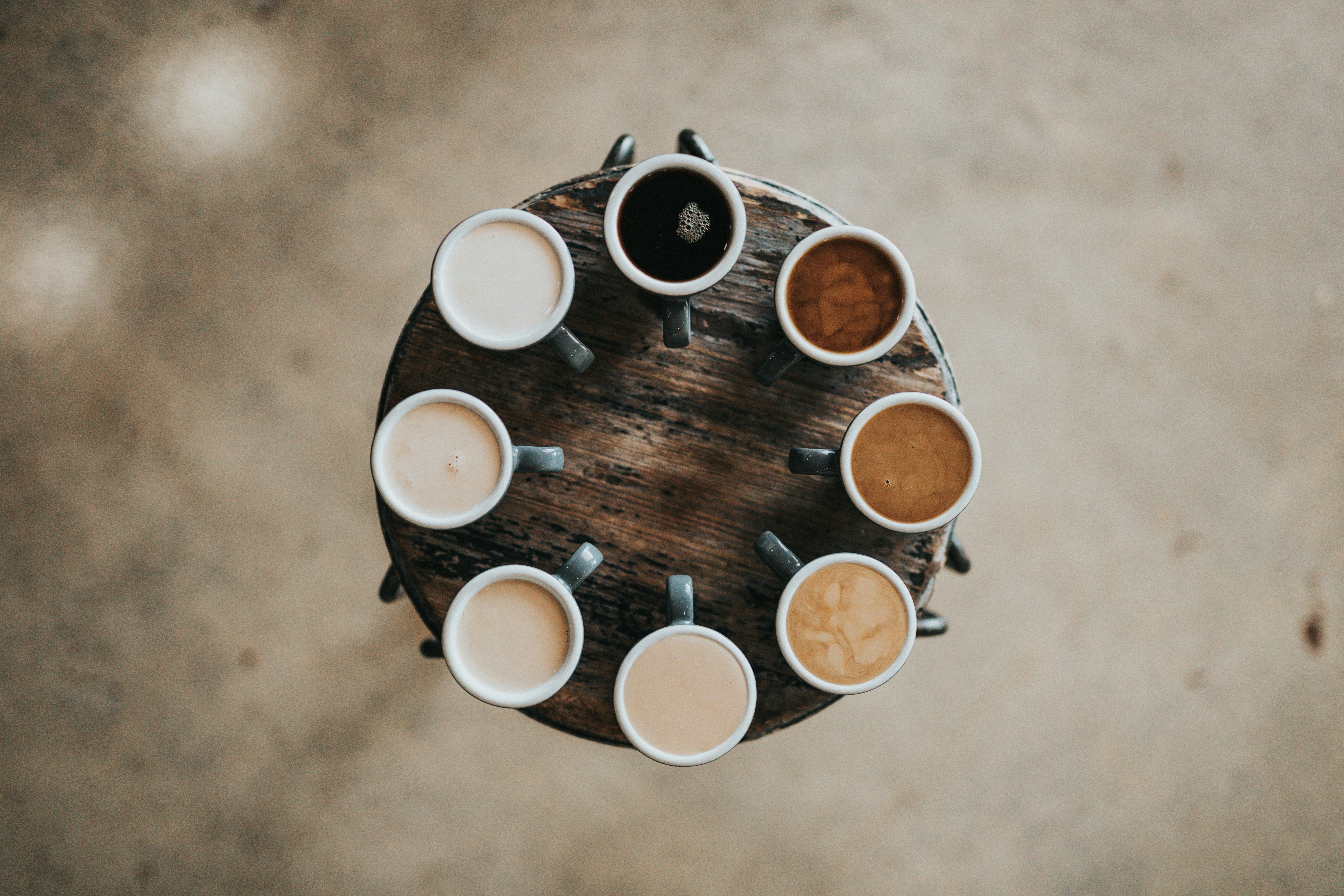 Personalization represented by coffee cups with different types of coffee servings in from milky white to black
