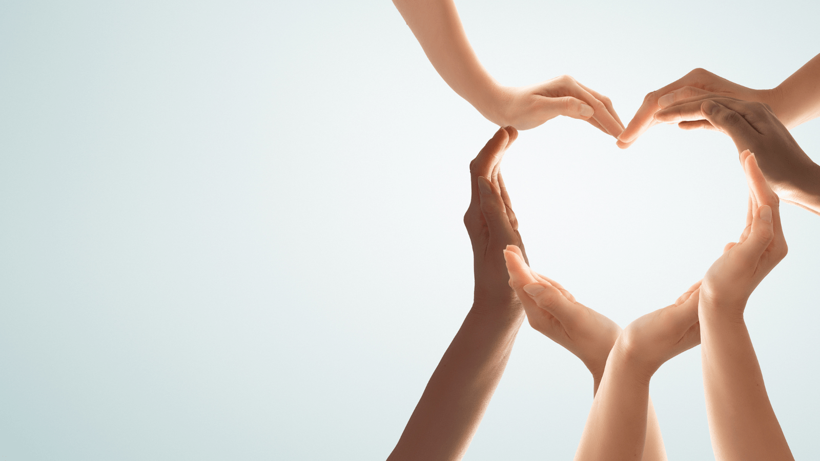 hands arranged in the shape of a heart